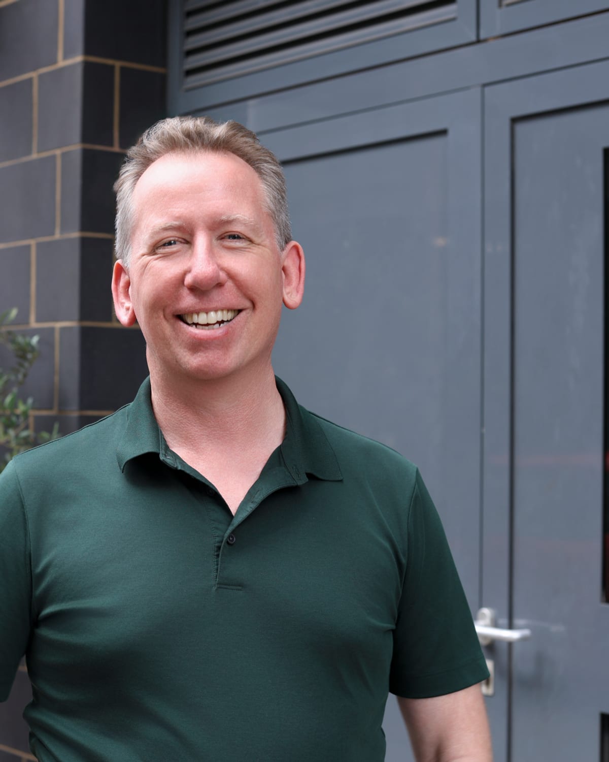 John Margerison laughing, in a green polo shirt