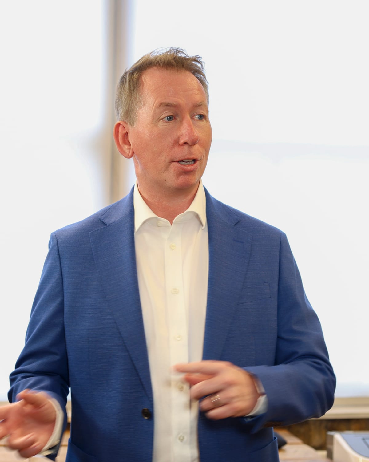 John Margerison speaking at a lectern to a room of managers